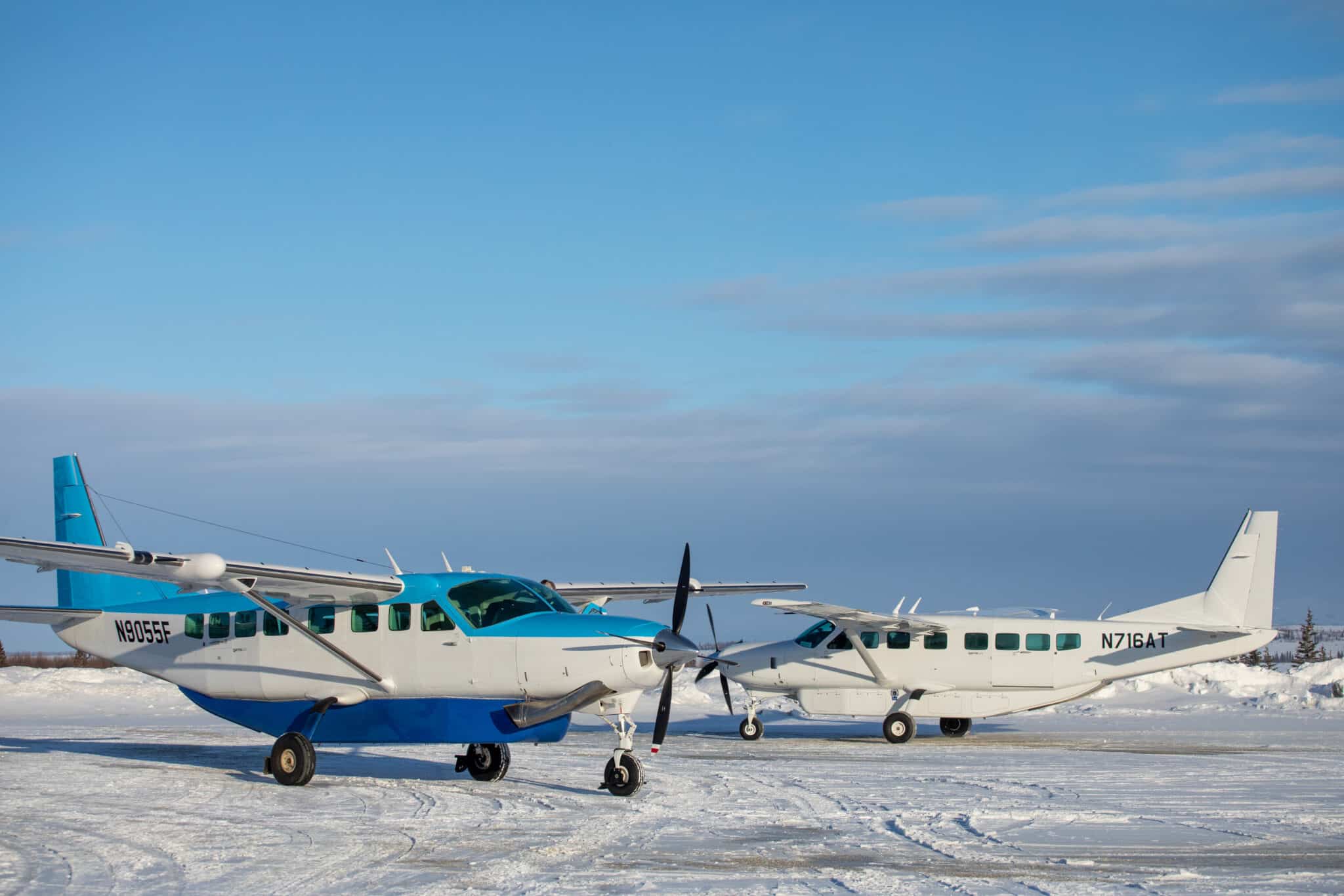 Caravan 208 aircraft parked on a snowcovered runway